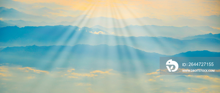 Mountains in fog sunset panorama landscape with sunset sky