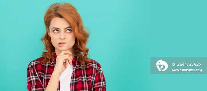 thinking redhead woman with curly hair in checkered casual shirt, decision. Woman isolated face portrait, banner with mock up copyspace.