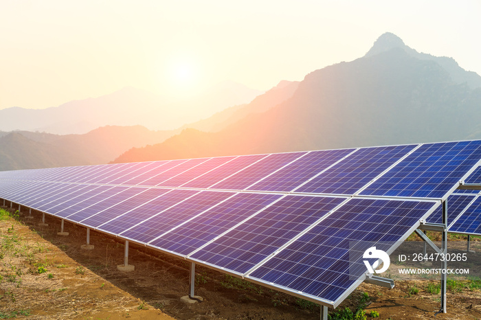 Solar panels and mountains landscape at sunrise