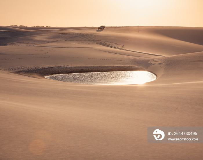 sand dunes of Lencois Maranhenses with blue water pools at sunset