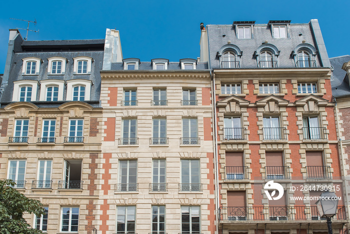 Paris, beautiful facades place Dauphine, with geometry of the windows, charming typical building in the center