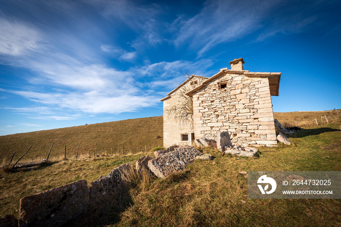 Old stone farmhouse with green and brown pastures in autumn. Lessinia Plateau (Altopiano della Lessinia), Regional Natural Park, Velo Veronese municipality, Verona Province, Veneto, Italy, Europe.