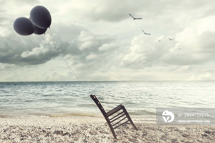 surreal image of a chair held in balance by flying balloons