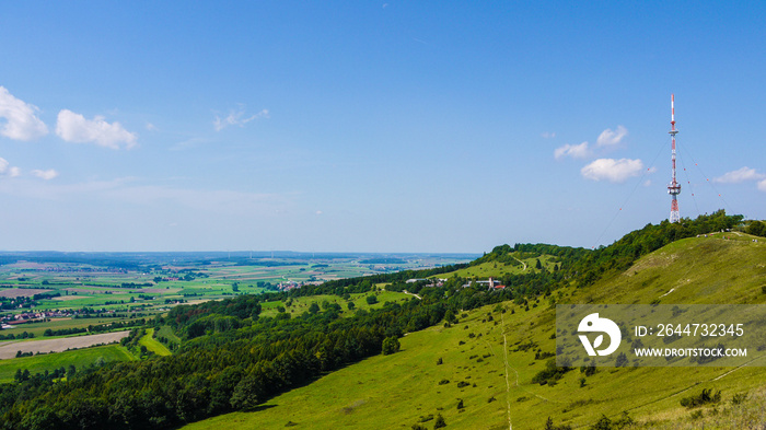 View of the top of the Hesselberg mountain in Bavaria, Germany. Taken on a sunny summer day and showing the telecommunication tower at the top and panoramic views.