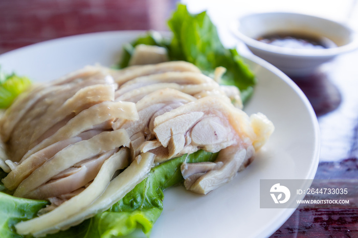 Slice of steamed chicken on plate