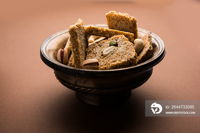 Gajak or til papdi or patti is a dry sweet cake - made of sesame seeds, ground nuts and jaggery, consumed in indian winter especially during Makar Sankranti festival on 14th january