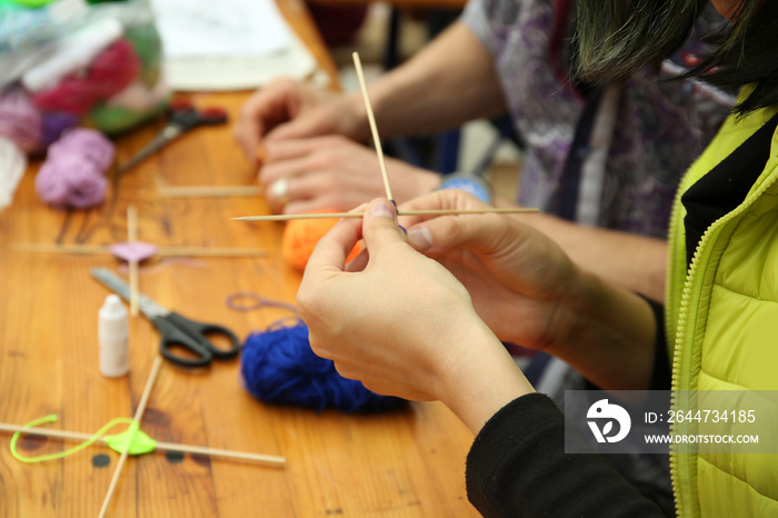 People knitting beautiful mandala on table close up