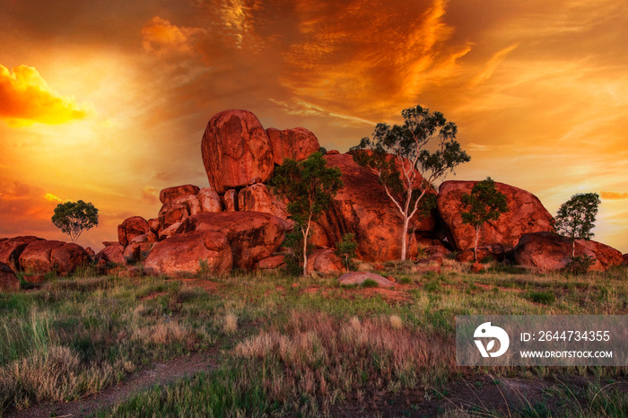 Sunrays at sunset light in Karlu Karlu - Devils Marbles Conservation Reserve. Australian Outback landscape in Northern Territory, Australia near Tennant Creek. Aboriginal land in Red Centre.