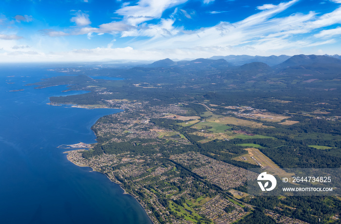 Aerial View of Qualicum Beach from an Airplane on the shore of Strait of Georgia in Vancouver Island, British Columbia, Canada. Colorful Blue Sky Art Render.