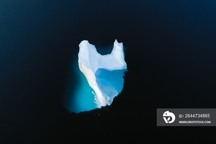 Aerial view of large glacier and iceberg