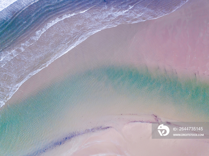 Aerial View looking down on a Welsh Beach in the UK. Taken 400 feet in the air, looking directly down on Deep Blue waves and beach