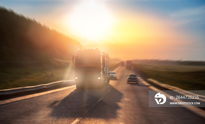 Truck driving on asphalt road in rural russia landscape with sun light, concept cargo transportation. Blur move effect