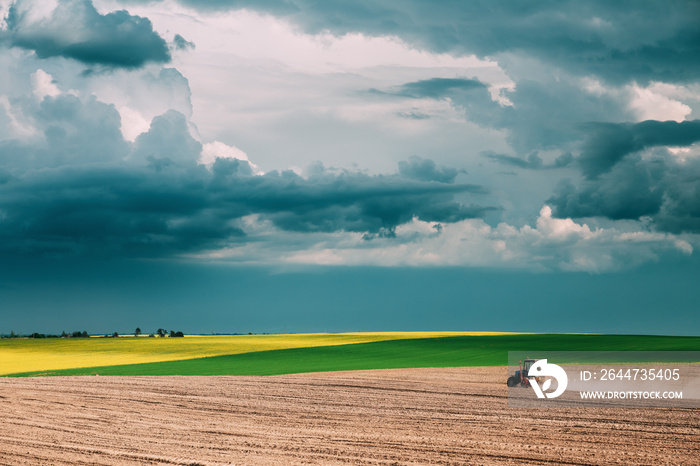 Tractor Plowing Field In Spring Season. Beginning Of Agricultura