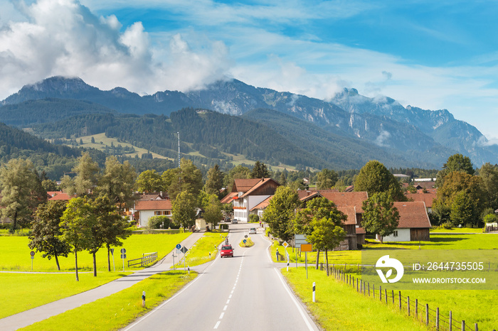 A picturesque and peaceful village with a road in the Alps. Travel and tourism concept