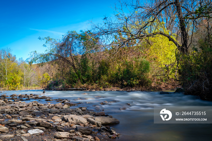 Water flowing over rocks in a river in northwest Arkansas during autumn