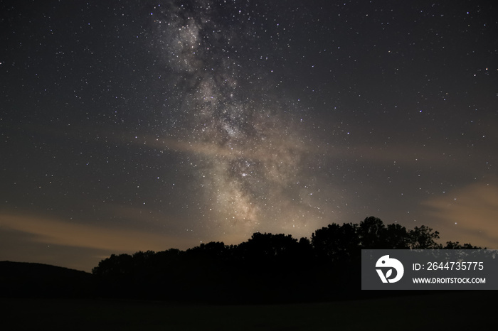 milky way above landscape silhouette