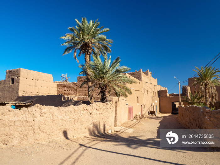Desert town of Mhamid, Morocco village with nature sand dunes and old muslim mosque in north Africa, old narrow streets, traditional clay mud architecture