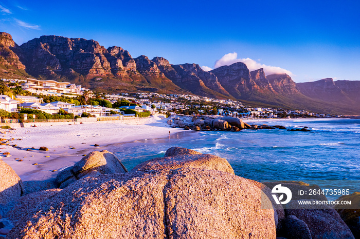 view of mountains and beach in camps bay, cape town, south africa at sunset