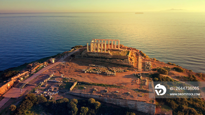 Aerial drone photo of sunset over the iconic Temple of Poseidon at Cape Sounio with amazing golden colours, Attica, Greece