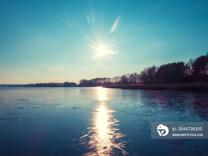 Frozen lake in the evening. Nature landscape