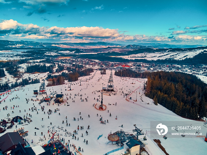 Beautiful panoramic aerial drone view to the ski slopes with lifts in the Bialka Tatrzanska ski resort Tatra Mountains (Tatras, Tatra) - mountain range between Slovakia and Poland