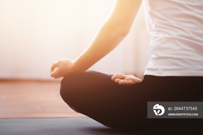 Close up woman meditates while practicing yoga in training hall or home. Concept freedom, calmness and relax, female health happiness.