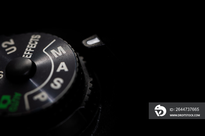 Close-up macro shot of a modern digital SLR camera with the dial in Manual Mode