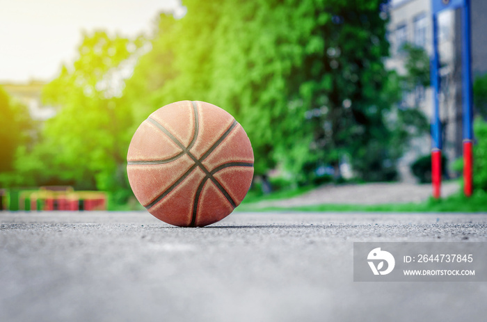 ball for playing basketball lies on the sports ground