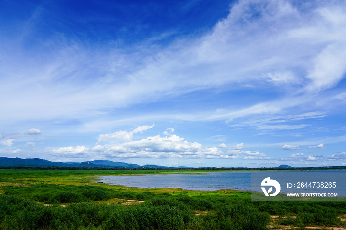 The view of the reservoir and plants green color during the rainy season with beautiful clouds. On a sunny day the sky is clear.