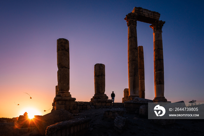 Silhouette of flying kites at the Temple of Hercules against clear sunset, Amman Citadel, Amman, Jordan