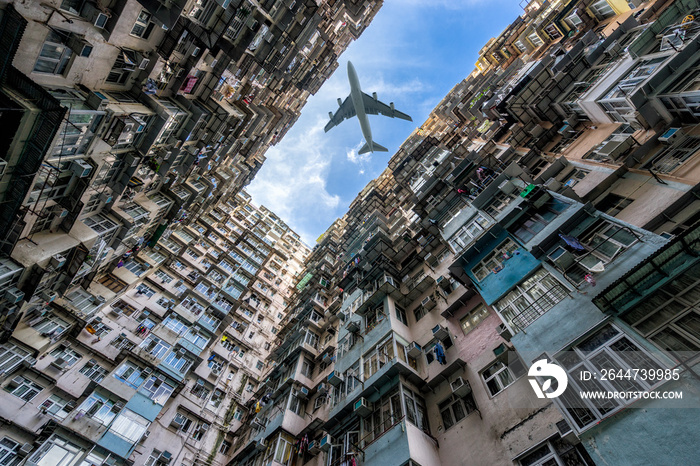 HongKong. Airplane flying over old tall and dense residential building in Hong Kong.