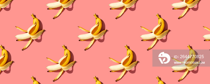 Yellow ripe  bananas on pink background pattern, banner