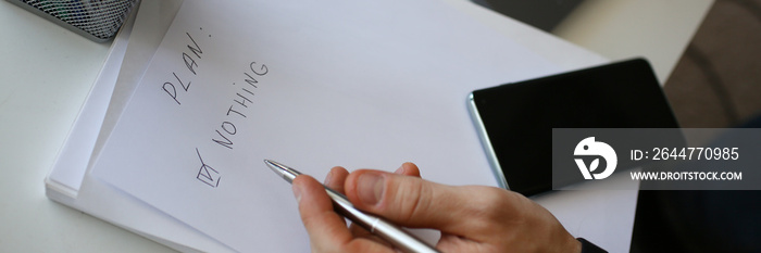 Male hand hold silver pen composing to do list for life closeup