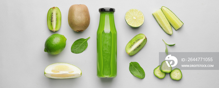 Bottle of healthy green smoothie and ingredients on light background, top view
