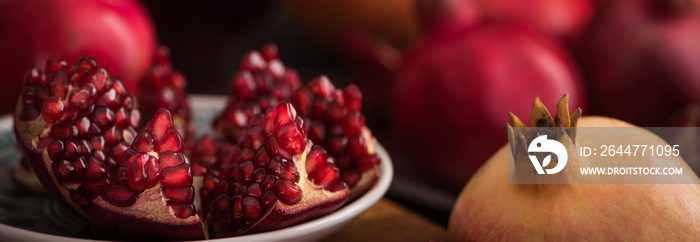 Cuted fresh pomegranate fruits on rustic background. banner maket. selective focus