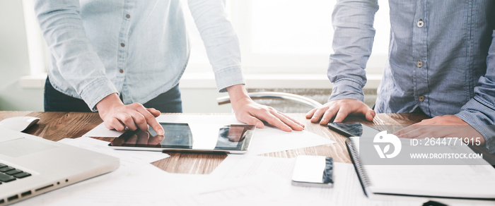 Website developers working using laptop at the office on wooden table. Website header or banner