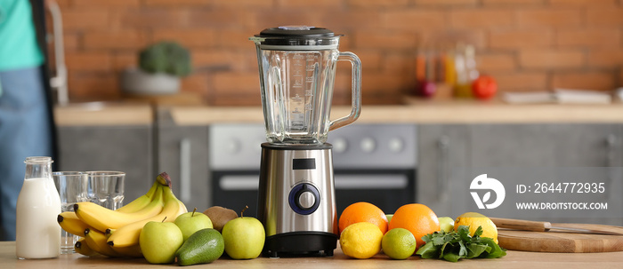 Modern blender and ingredients for healthy smoothie on kitchen table
