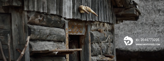 Traditional viking age village. Birka, Björkö island, lake Mälaren, Sweden. Wooden house (log cabin) exterior, skull. Atmospheric landscape. Landmarks, tourism, history, historical reenactment, craft