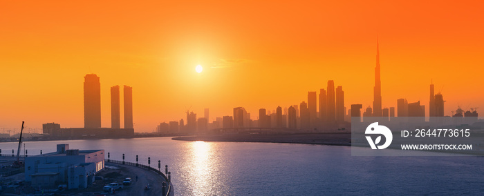 Panoramic view of all skyscrapers from Dubai Creek sea Bay at golden hour sunset. City life in the UAE concept