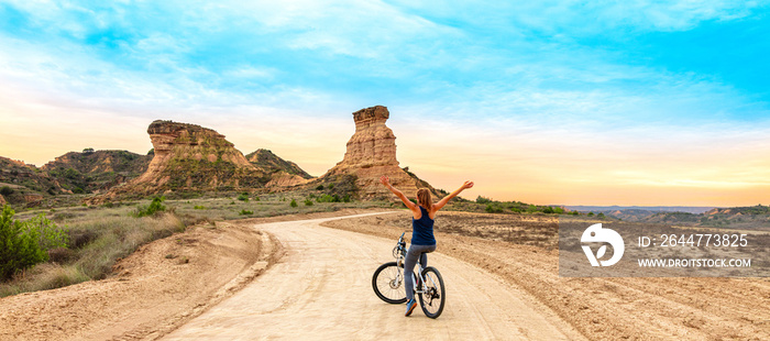 Happy woman in mountain bike ( Monegros desert in Spain)