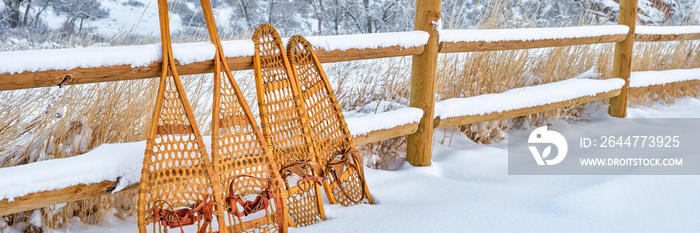 classic wooden snowshoes in winter scenery at foothills of Rocky Mountains in northern Colorado, panoramic web banner