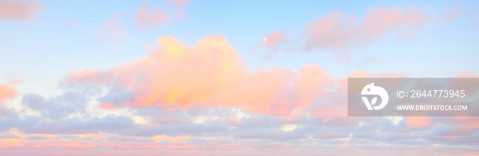 Clear blue sky. glowing pink and golden cirrus and cumulus clouds after storm, soft sunlight. Dramatic sunset cloudscape. Meteorology, heaven, peace, graphic resources, picturesque panoramic scenery