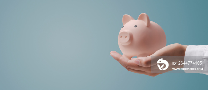 Doctor holding a piggy bank