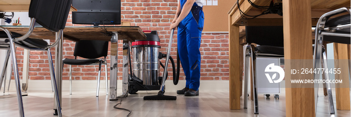 Janitor Cleaning Floor With Vacuum Cleaner