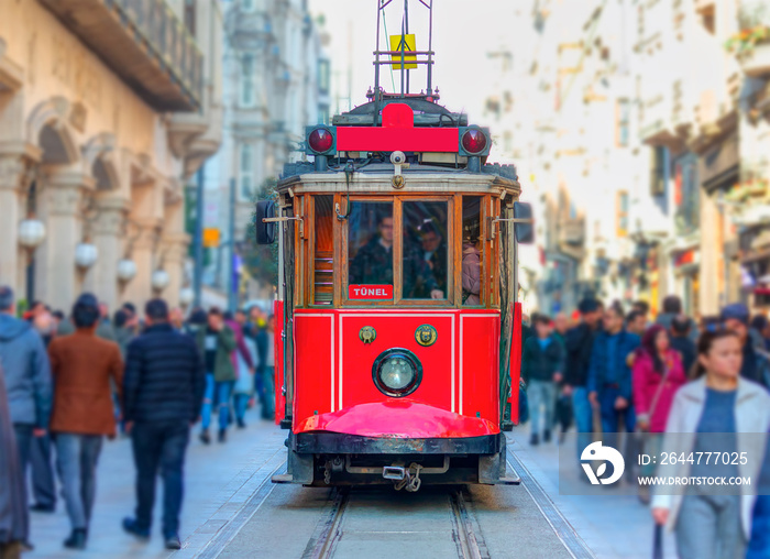 Nostalgic retro red tram on famous Istiklal street. Istiklal Street is a popular tourist destination in Istanbul.