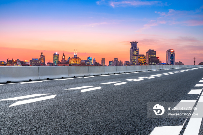 Sunset asphalt road and city skyline in Shanghai