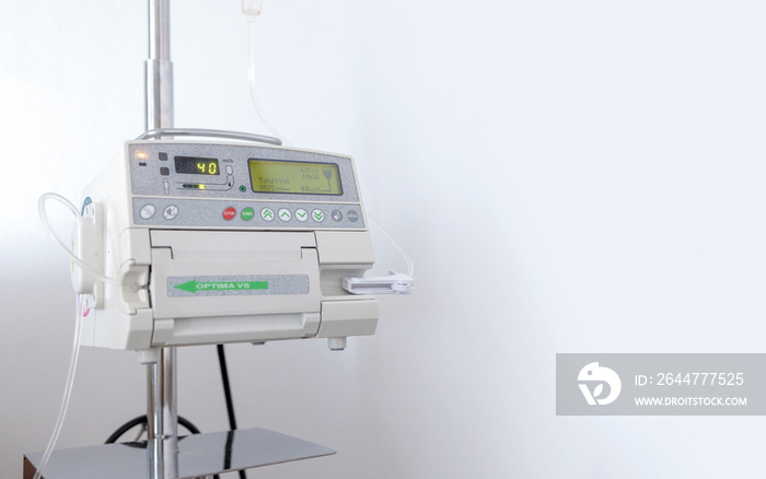 closeup adjust infusion pump set iv fluid intravenous drop saline drip on white background in a hospital.