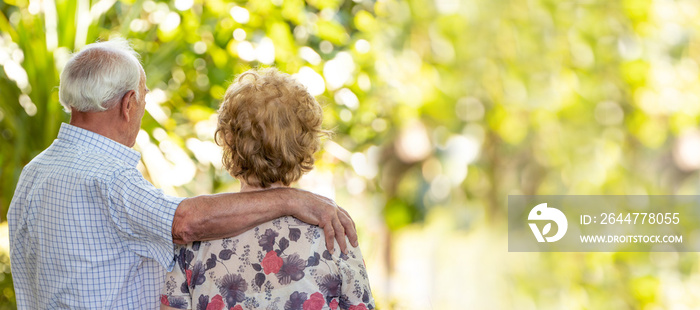 senior older couple cuddling outdoors