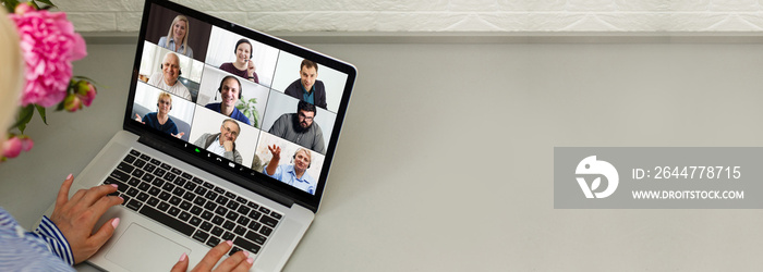 Back view of female employee speak talk on video call with diverse multiracial colleagues on online briefing, woman worker have Webcam group conference with coworkers on modern laptop at home