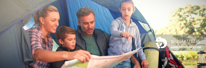 Family reading the map in tent